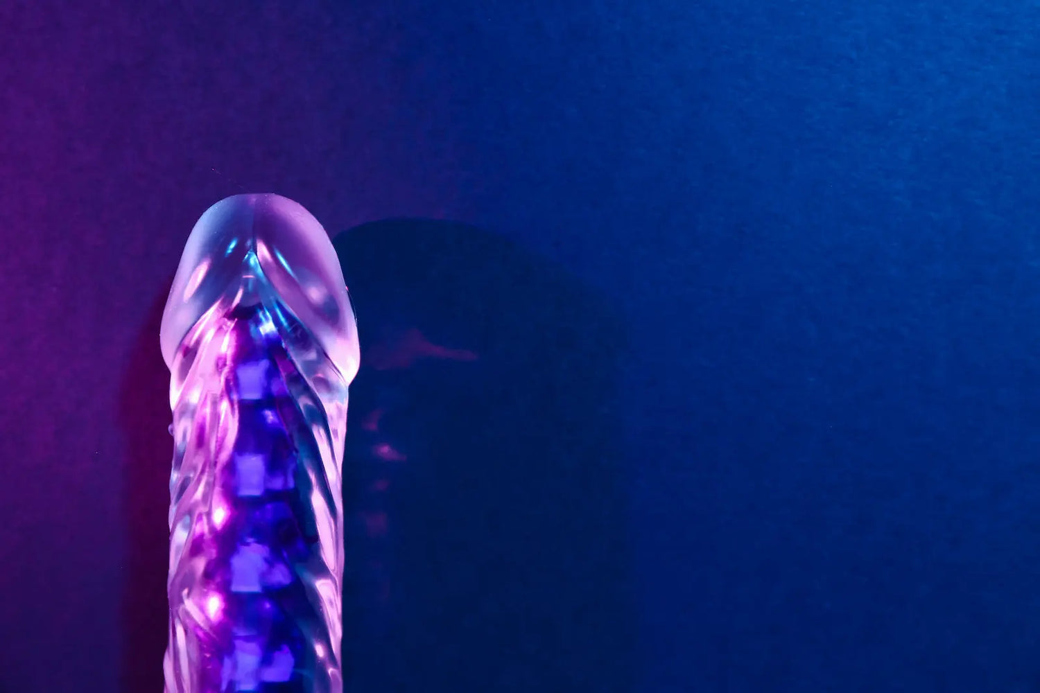 clear plastic penis shaped dildo with a side purple light shine  - Flutters.ie